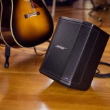 Bose S1 Pro PA System in tilt-back position with a guitar