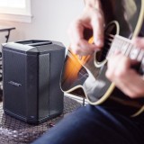 Musician using the Bose S1 Pro for a practice amplifier