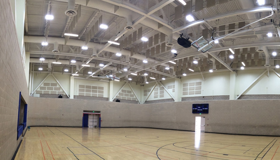 gymnasium with hanging acoustic dampening panels